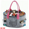 Grey felt tote with pink handles holding an audio box and figurines in elastic side loops